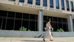 In this August 2020 photo, a person walks past the US Department of Education in Washington, DC. 